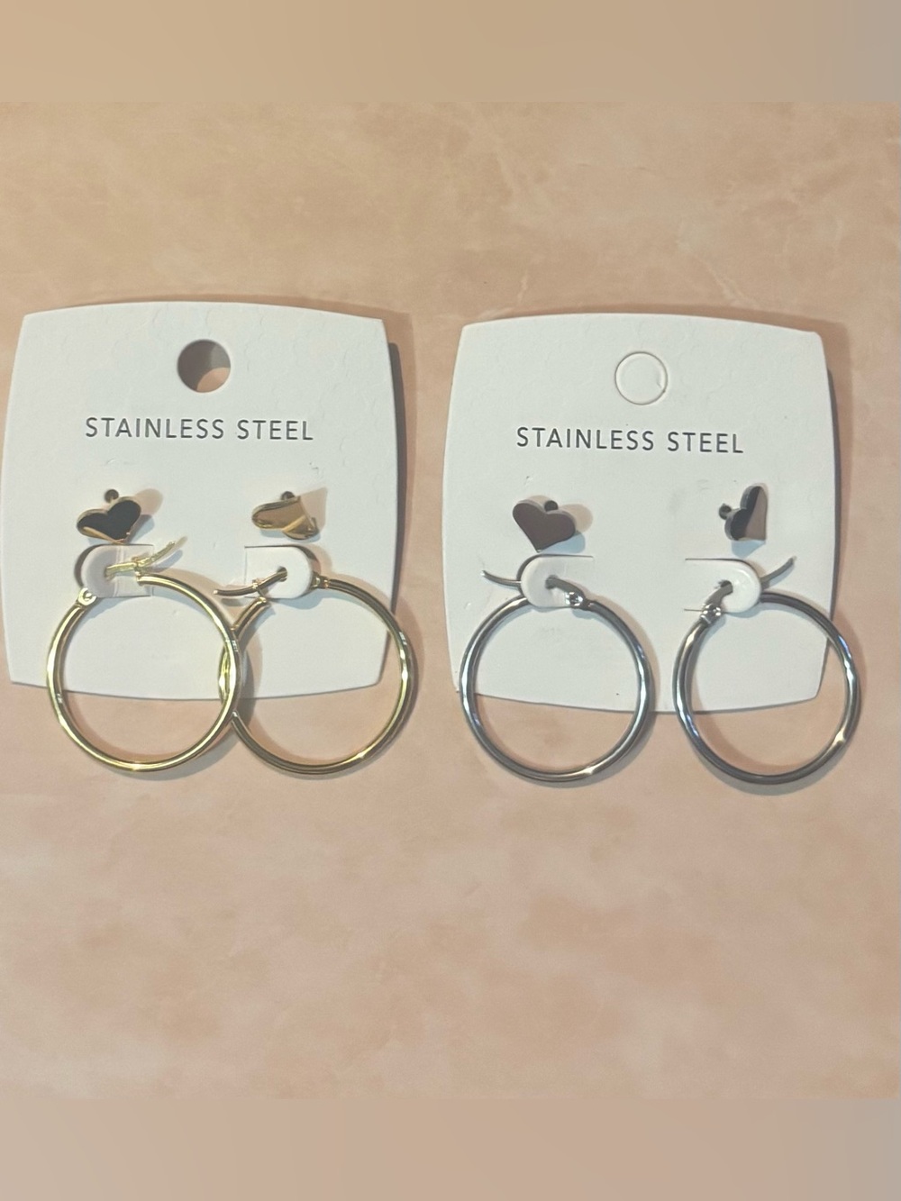You get both Stainless Steel Heart Stud Hoop Earring sets - Gold and Silver